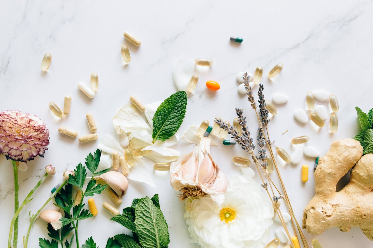 why-choose-us A flatlay of natural herbs, supplements, and flowers on a marble background.